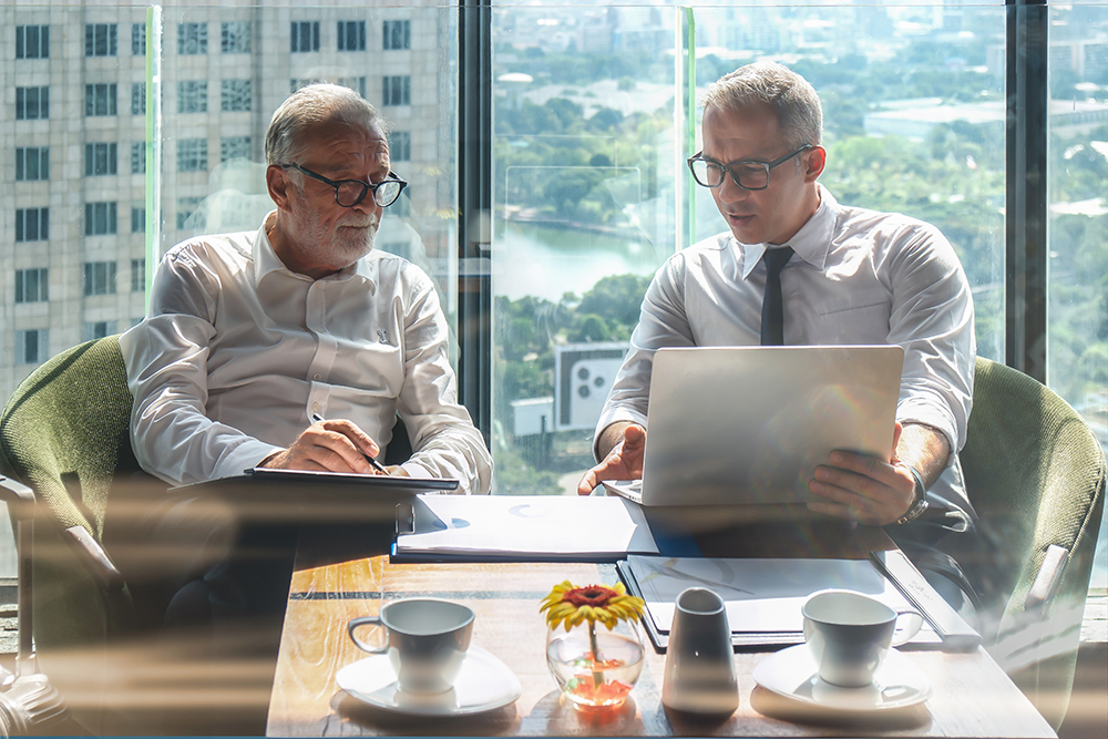 senior and young businessmen meeting